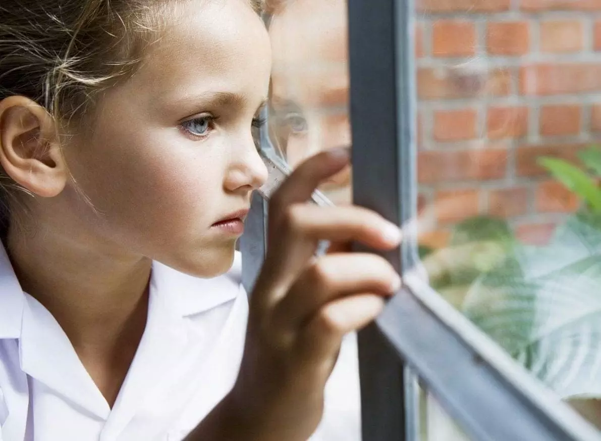 Child looking out window.