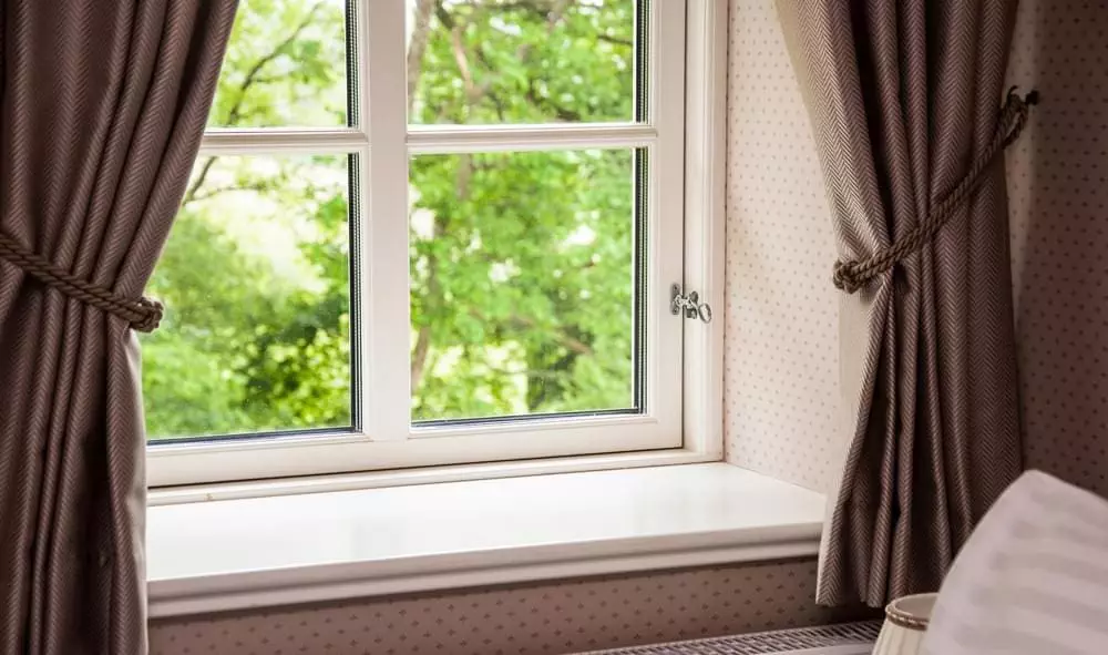 window Curtain tied back to show corner of window.